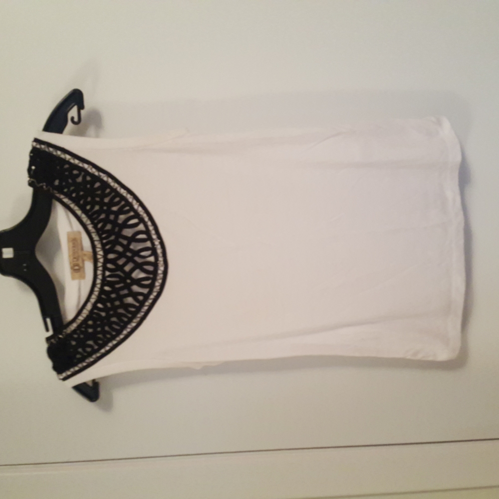 White sleeveless top with wide black collar